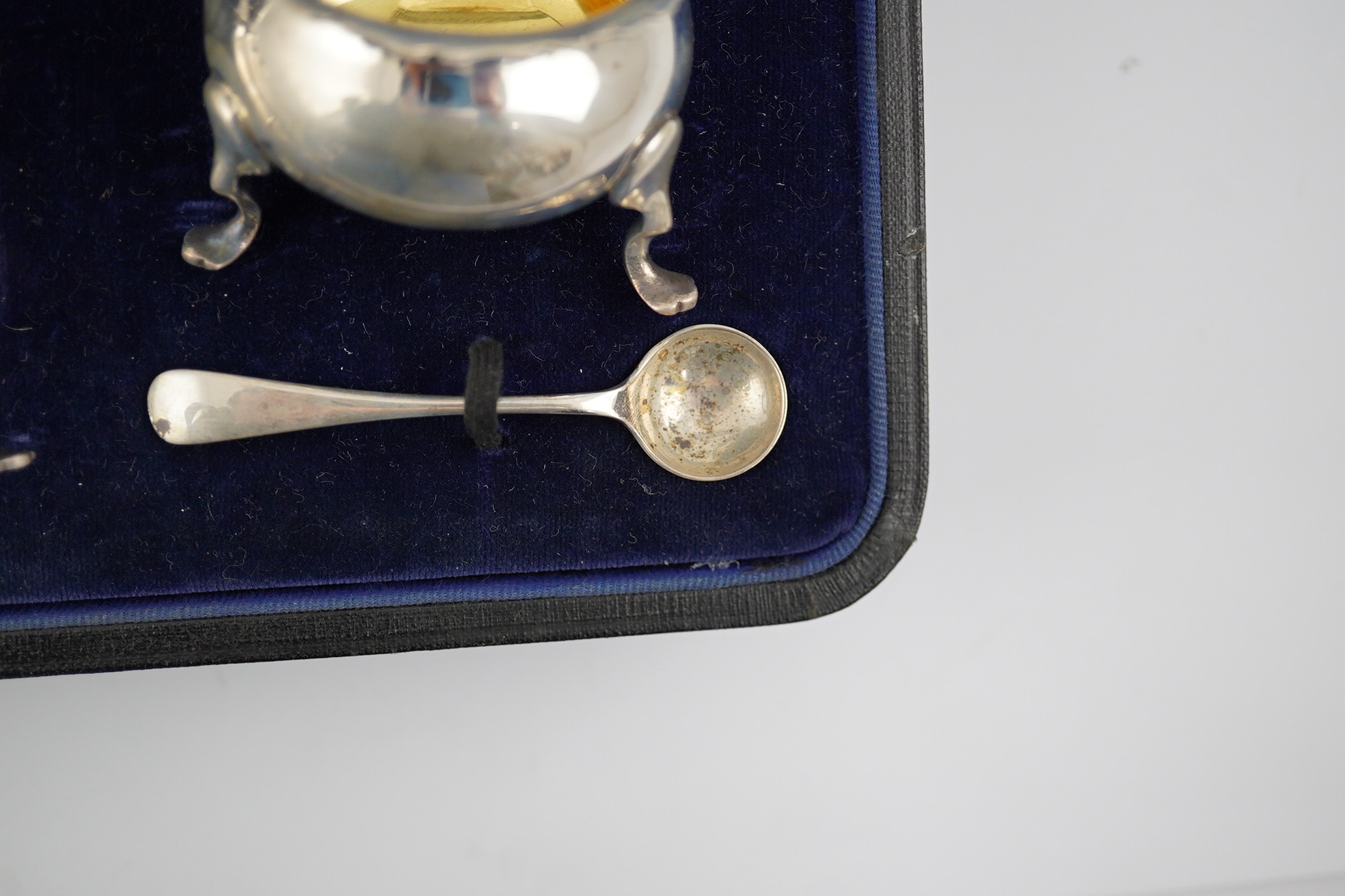 A George V cased silver seven piece condiment set by Horace Woodward & Co Ltd, Birmingham, 1918, with five associated silver condiment spoons. Condition - poor to fair